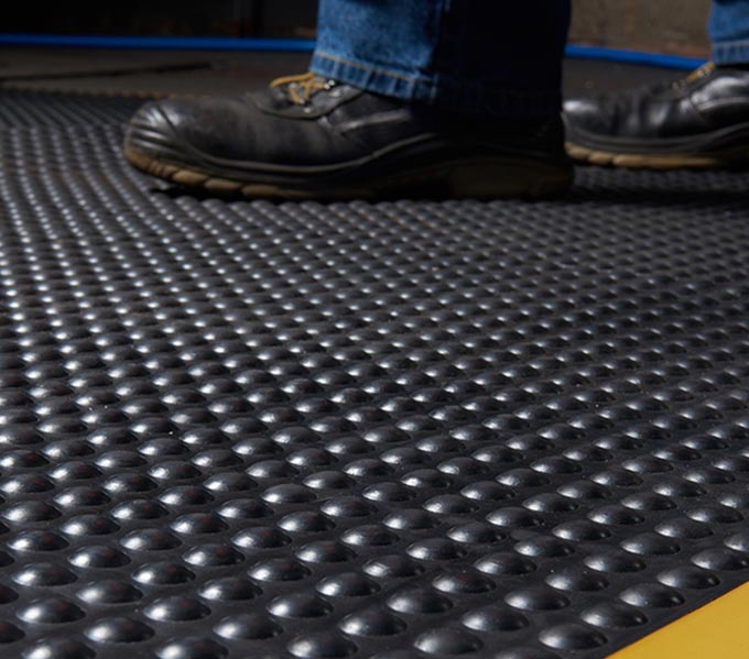 Commercial photography of floor matting and workman